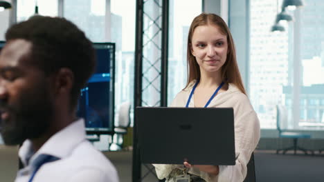 portrait of young smiling female programmer in office automating with ai