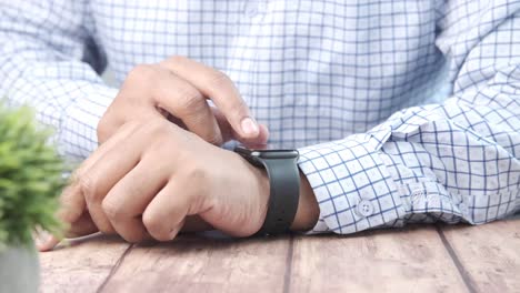 person checking time on smartwatch