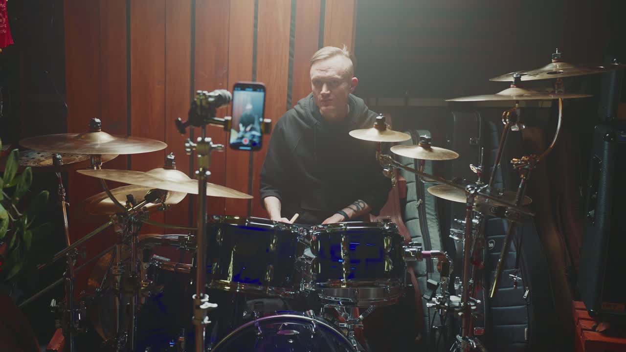 Drummer teaching a lesson on video