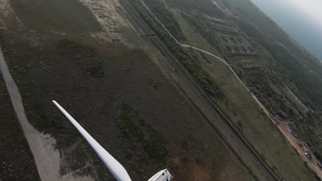 aerial view of rural landscape with wind turbine