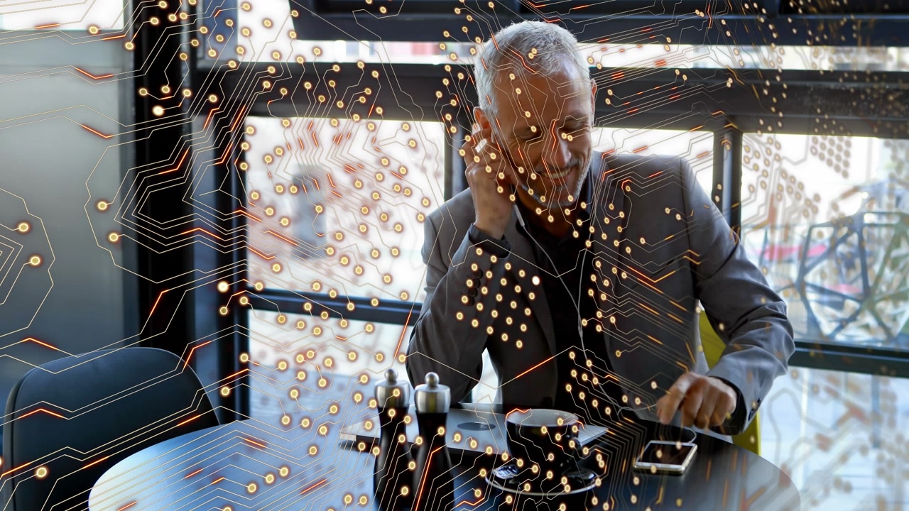 Animation of microprocessor connections over caucasian senior businessman talking on smartphone