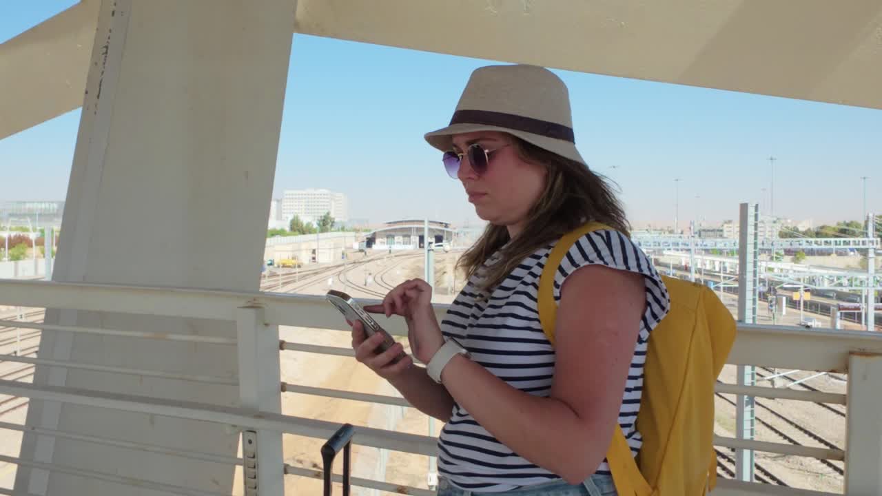 Tourist Engaged with Phone in Transit