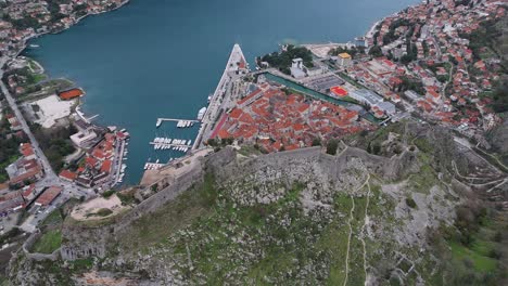 4k drone footage captures kotor fortress and unesco-listed old town and port in the bay of kotor, montenegro