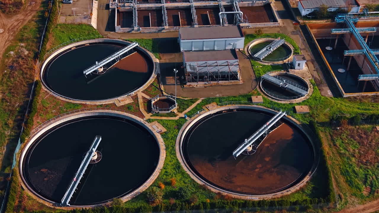 Big and small round water tanks for sewage recycling. Aerial perspective on the territory of modern sewage treatment plant