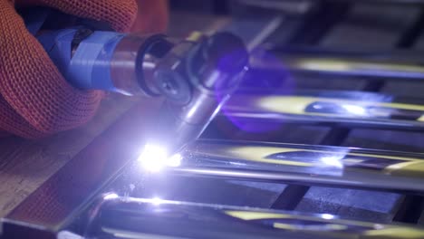 man wearing mask welding in a workshop. metal workers use manual labor. skilled welder. welder is welding the stainless steel pipes in the factory. welder industrial part in factory.