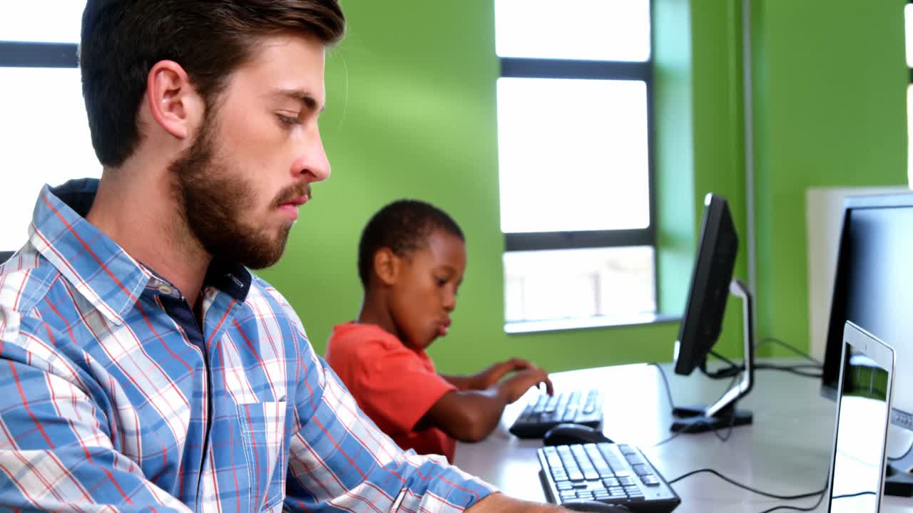 Teacher using laptop in classroom