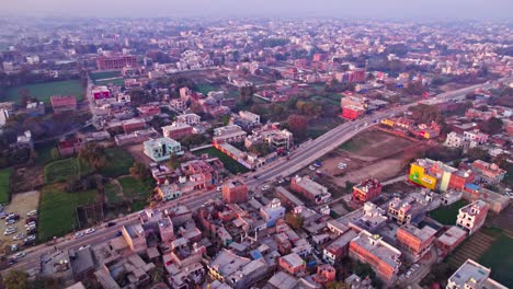 crowded buildings with road and farming land at ayodhya, uttar pradesh, india. day time, push in, drone shot, 4k.