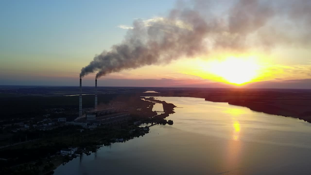Factory Pipe Polluting Air. Factory pipe polluting air against sunset, environmental problems, smoke from chimneys