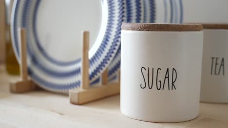 kitchenware with sugar and tea canisters and plates