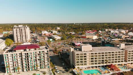 Schwenk-über-Myrtle-Beach-Mit-An-Der-Strandpromenade-Aufgereihten-Resorts-Und-Sanft-Am-Ufer-Krachenden-Wellen