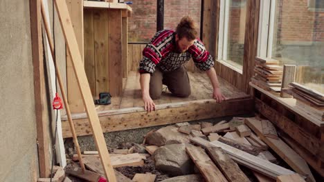 worker installing wood interior of greenhouse. static shot