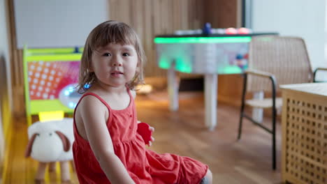 Shy-Timid-Adorable-3-Year-Old-Toddler-Girl-in-Arcade-Machine-Playroom---slow-motion