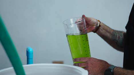 pouring green liquid into a container