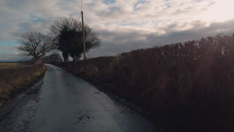 pov shot road riding a road bike cycling on sunny wet country lane in england