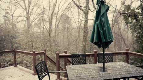 a still shot of snow falling down on a back porch of a duplex