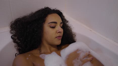 mujer relajándose en un baño de burbujas