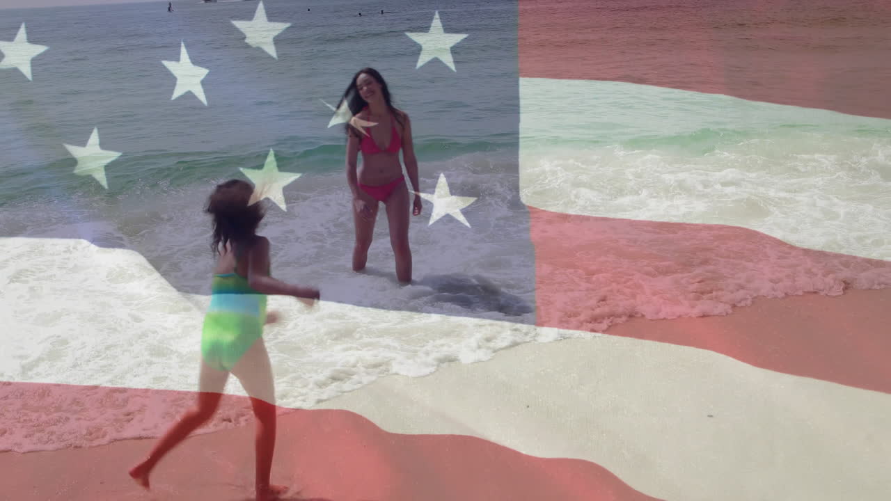 On beach, woman and child playing with American flag animation overlay