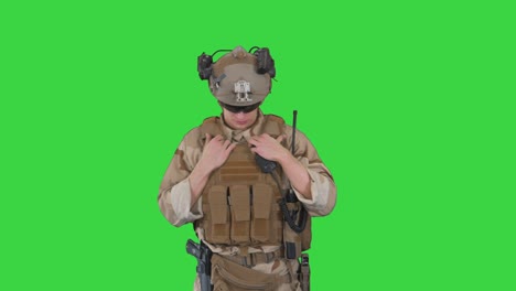 soldier ranger in ammunition saluting on a green screen, chroma key