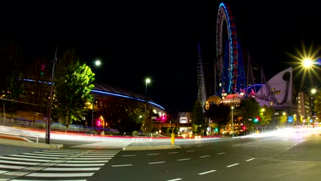 lapso nocturno 4k incluyendo el domo de tokio rueda de ferris tiro ancho