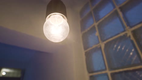 hanging edison bulb light in a room with brick wall