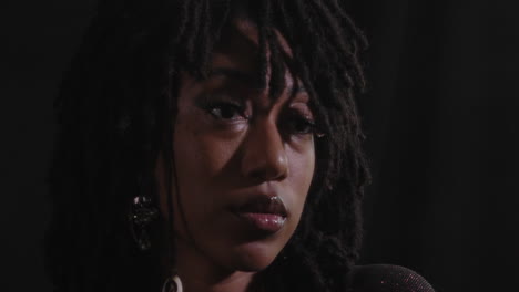 portrait head shot of young african american women with black background