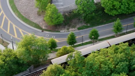 drone shot of atlanta metro rail crossing through georgia state route 400, t harvey mathis parkway