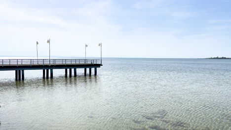 a peaceful wooden dock over calm waters - jurata, poland