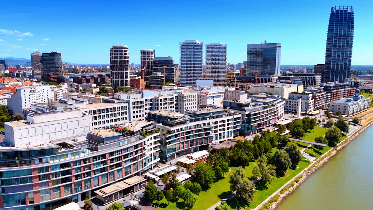 Bratislava, Slovakia - June 14, 2025: Bratislava skyline by the Danube. Bratislava's skyline blends modern architecture and greenery, showcasing urban life by the sunny Danube River