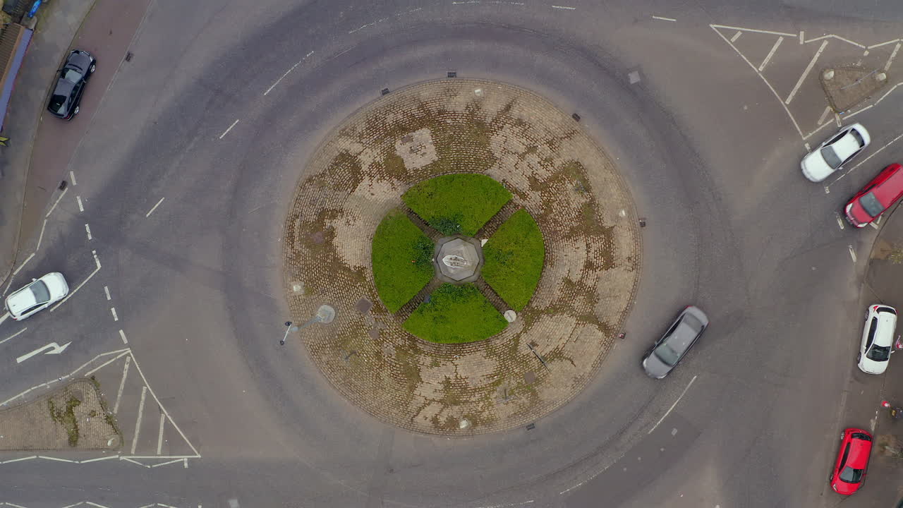 Top-down aerial ascend over Carlisle Circus roundabout with moderate traffic on Patrick's day. Belfast