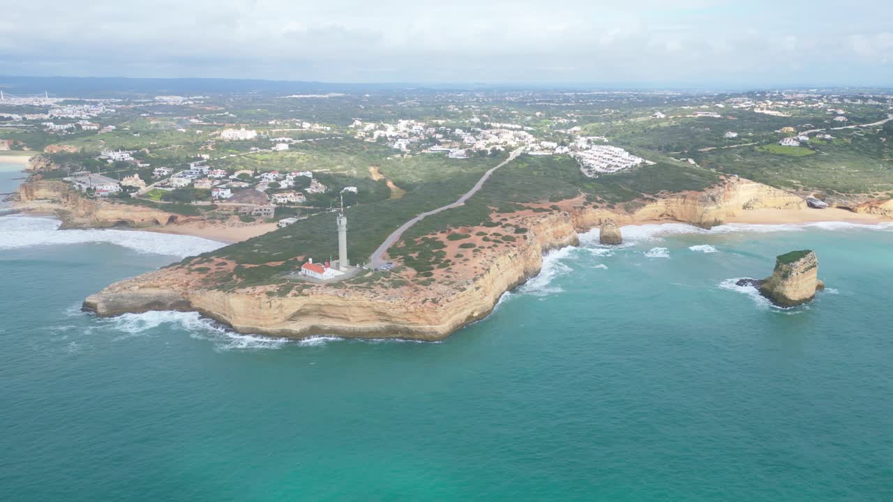Rocky coastline and lighthouse at Ferragudo, Algarve, Portugal, seen from above