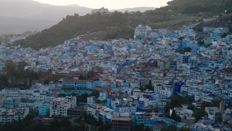 panoramic view of chefchaouen, blue city in the mountain in morocco. - aerial shot