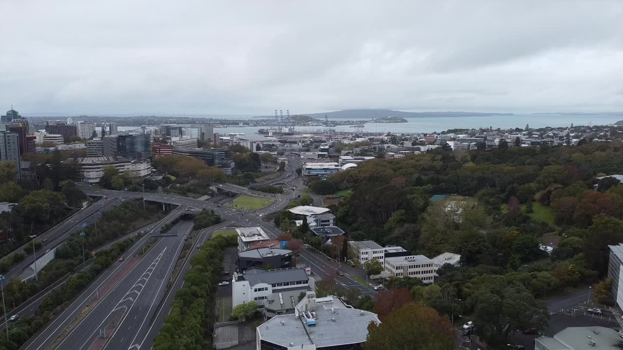 drone shot of casual traffic of auckland city and rangitoto island