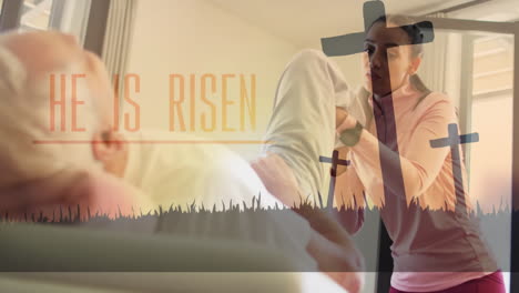 assisting elderly man at home, woman with animation of he is risen text