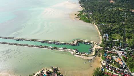 wok tum canal for boats to reach city trough shallow water, aerial view