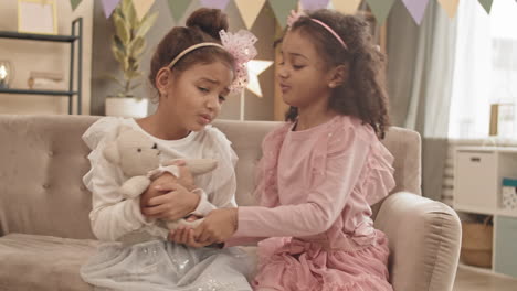 sisters fighting over toy bear