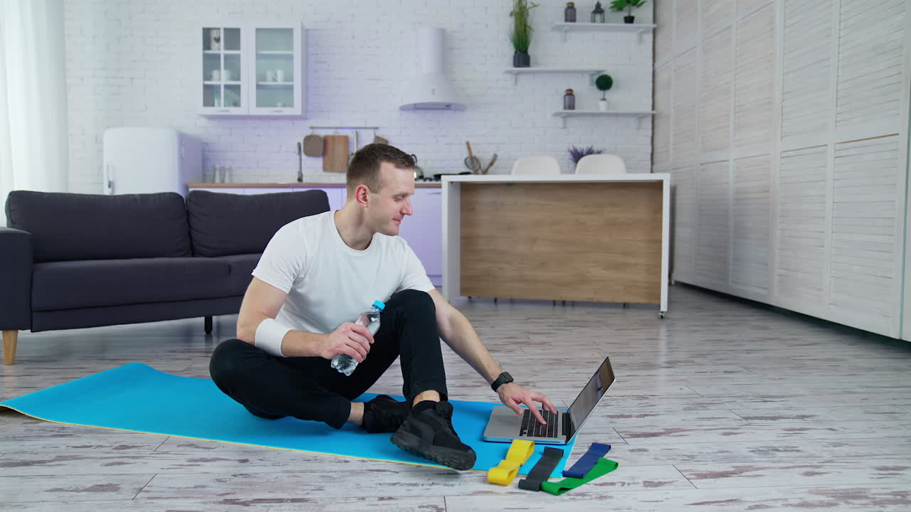 Indoor training on quarantine. Handsome athletic man doing exercise in home.