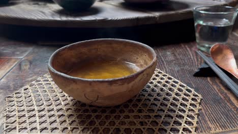 japanese ceramic bowl with tea on table