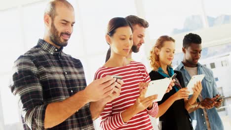 Group-of-colleagues-using-electronic-devices