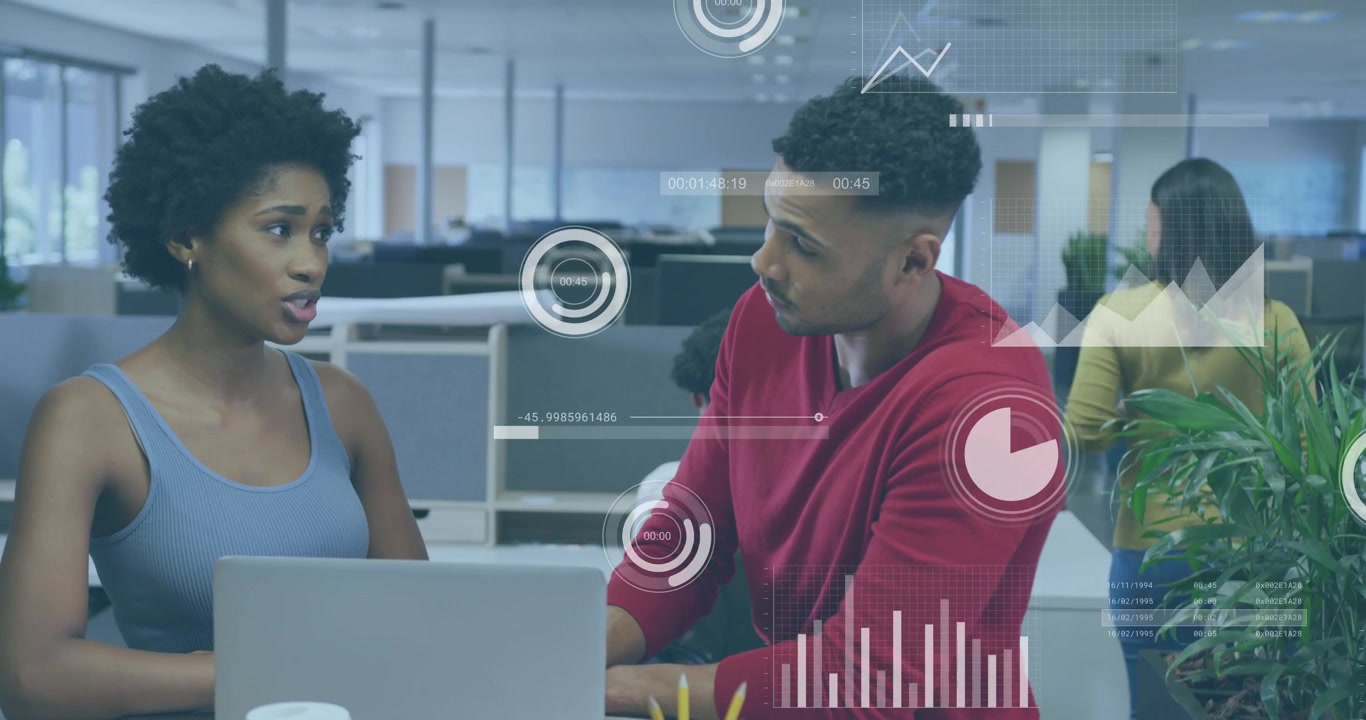 Seated woman pointing at laptop, man leaning in examining charts, HUD highlighting business metrics