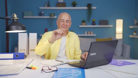 home office worker old man waving at camera.