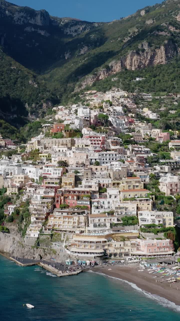 Vertical Video of Italy's Most Iconic and Picturesque Beachfront Town. Positano Village with Pastel-colored Houses on a Cliffside with Turquoise Water Beachfront