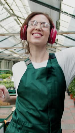 woman dancing in a greenhouse