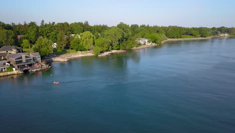 Aerial-view-of-attractive-waterfront-homes-in-a-scenic-small-town