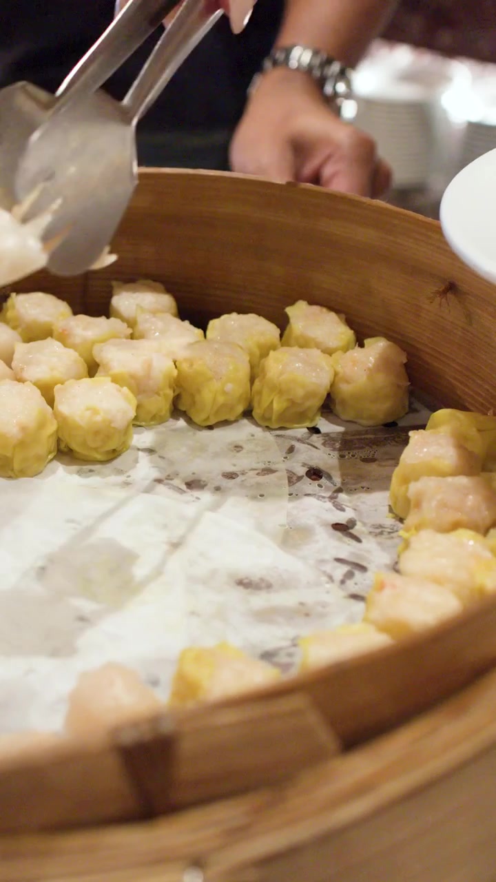 Serving Steamed Dim Sum Dumplings from a Bamboo Steamer