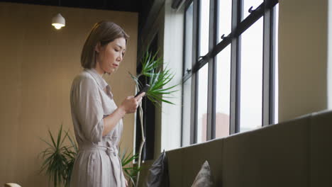 animation of question marks over asian businesswoman working at office