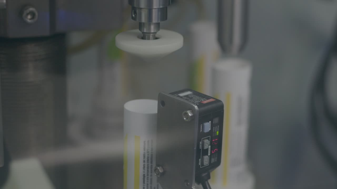 high-precision, advanced machine that aligns metal tubes for medications with accuracy, using automation and sensors to ensure optimal positioning.