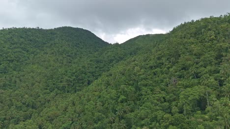 Aerial-of-tropical-forest-covered-hilltops-near-Mahucdam-Lake,-Surigao-Del-Norte,-Philippines