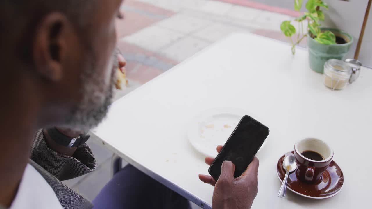 African American man eating in a coffee