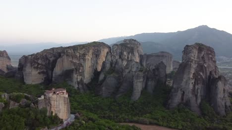 Aerial-Panoramic-Shot-of-Rousanou-Monastery-and-Meteora-Rocks,-Kalambaka-Greece,-Blue-Hour-Lighting,-Drone-Footage