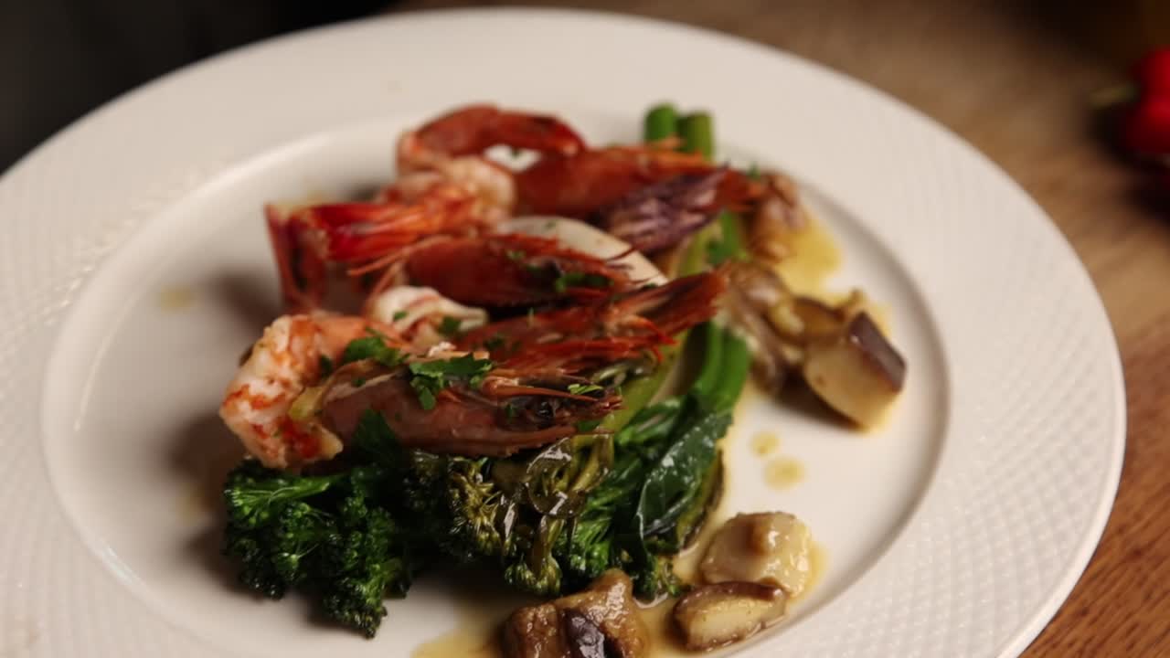 Chef Plating a Gourmet Seafood Dish with Shrimp and Vegetables